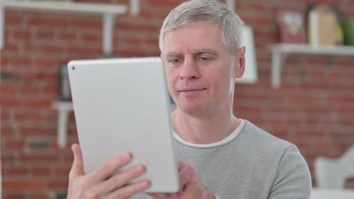 Adult Using a Tablet Indoors