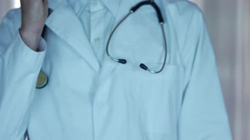 Doctor Using Phone with Stethoscope and White Coat
