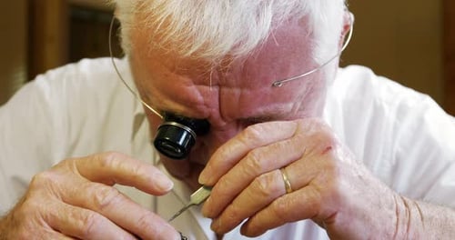 Close-up of horologist repairing a watch