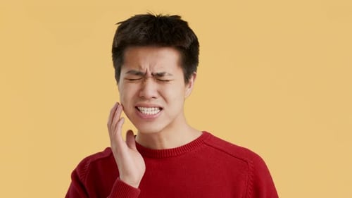 Chinese Man Having Aching Tooth Suffering From Pain Orange Background
