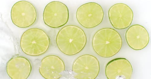 Lime Slices with Water Splash Overhead