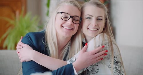 Two Happy Women Embracing Indoors