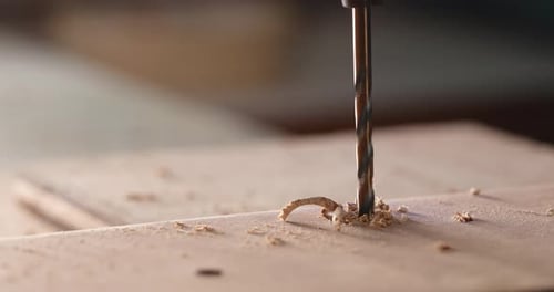 Drill Bit Drilling Into Wood in Close Up Shot
