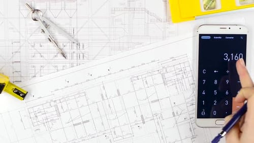 Architects Compare the Calculations with the Drawing, and Discuss Further Cooperation. Close Up