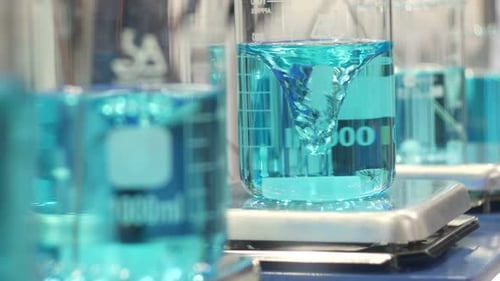 Turquoise Liquid Stirring in Beaker in Laboratory