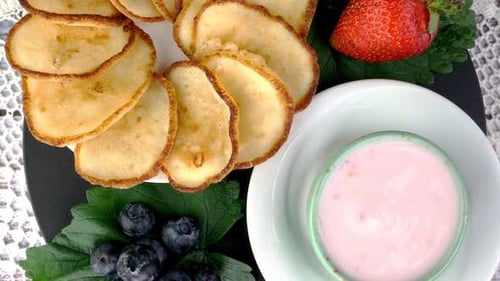 Fried Pancakes on Plate with Strawberriesblueberries and Whipped Cream Rotate Slowly on Turntable