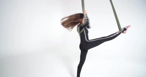 Young Woman Performs Aerial Silks Acrobatics Routine