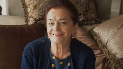 Smiling Senior Woman Relaxing on Couch