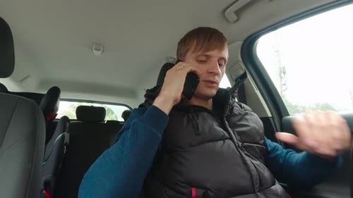 Man Talking on Phone in Car
