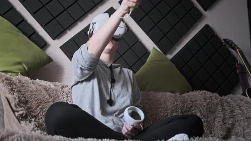 Woman Uses Virtual Reality Headset on Couch