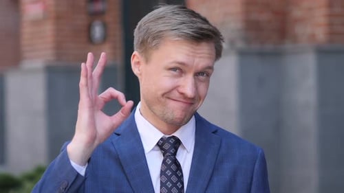 Man in Suit Gives Okay Hand Gesture