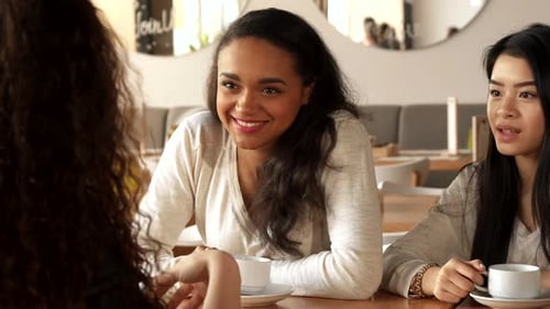 Three Female Friends Chat at the Cafe