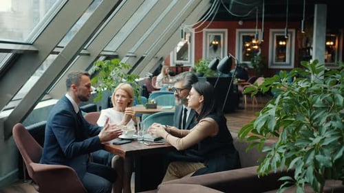 Joyful People Coworkers Enjoying Communication in Cafe During Lunch Break