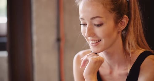 Fit Young Woman Using Smartphone In Gym