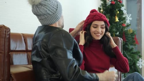 Couple Celebrate Christmas With Affection and New Hat