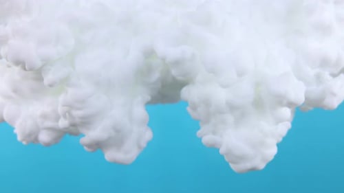 Expanding White Ink Plumes on Blue Background