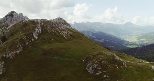 Aerial Drone Flight Establisher Over Green Cloudy Mountains Peaks