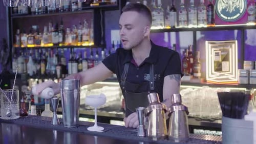 Bartender Preparing a Cocktail at a Bar