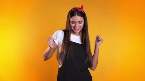 Woman Talking with Hand Gestures on Yellow Background