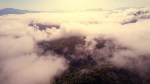 Aerial view from a drone over mountain fog during sunrise