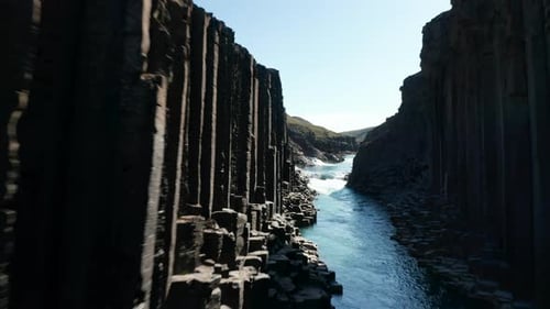 Drone View of Majestic Canyon with Volcanic Basalt Columns in Iceland and Glacier Water River
