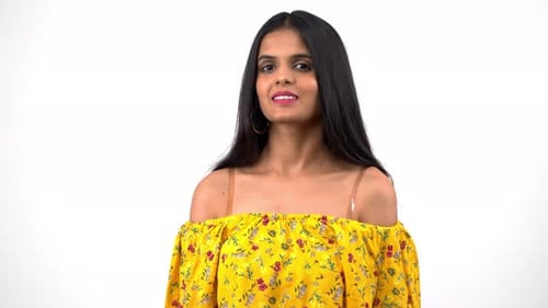 Woman Smiling and Posing in Yellow Floral Blouse