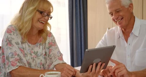 Senior Couple Enjoying Tablet Technology at Home