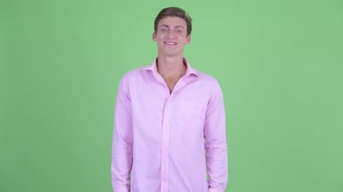 Smiling Young Adult Man Posing in Pink Shirt