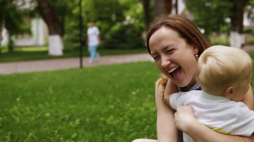 Child Runs to Mother for Hug in Park