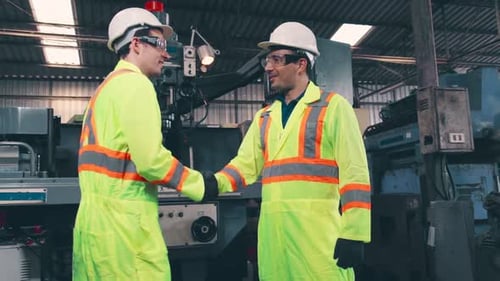 Factory Workers Handshake with Team Member in the Factory