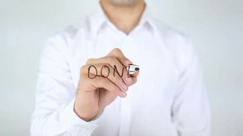 Man Writes Word Done with Marker