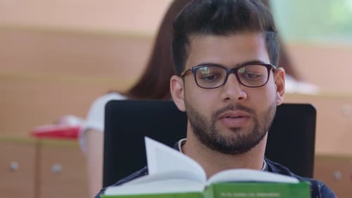 Male Student Reading Book Loud.