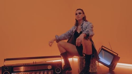 Stylish Woman Squats in Studio with Vintage Tech