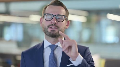 Professional Man Talking to Camera in Office Setting
