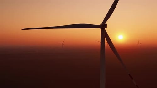 Wind Turbines Silhouetted Against a Vibrant Sunrise
