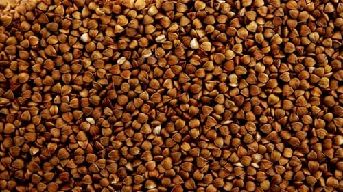 Pouring Buckwheat Grains Creates Textured Pile