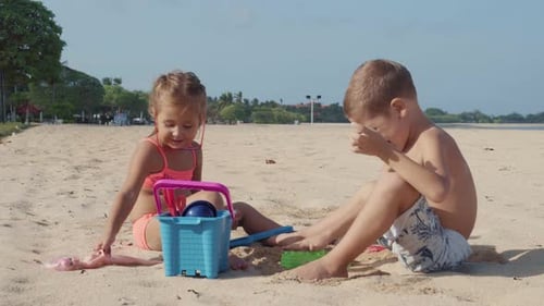 Two Children Playing Toys on the Beach