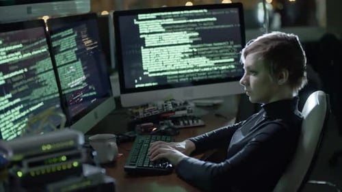 Female Programmer Writing Program Code at Night