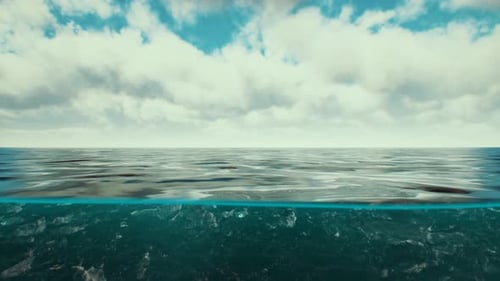 Split View Over and Under Water in the Caribbean Sea with Clouds