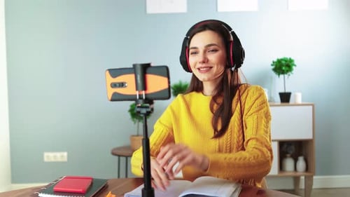 Woman Video Conferencing with Smartphone and Headphones