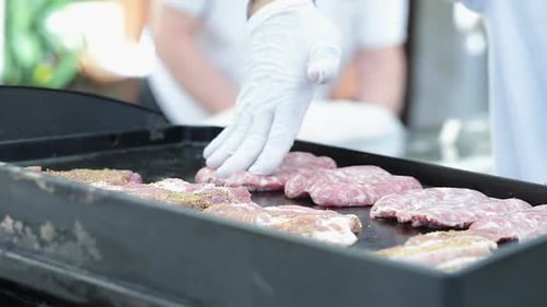 Meat Placed on a Flat Top Grill