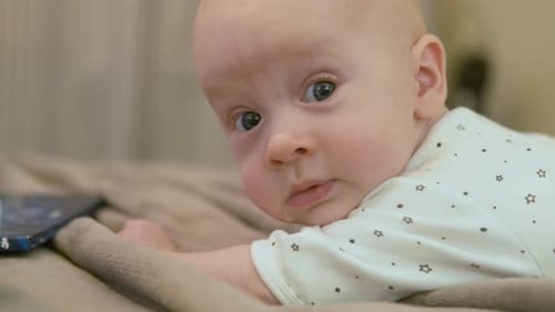 Infant Lying on Stomach on Blanket