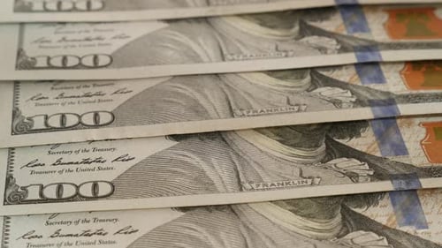 Tilting over USD paper currency in 100 denominations 4K 2160p 30fps UltraHD footage - Slow tilt on U