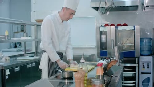 Chef Cuts Food in Commercial Kitchen