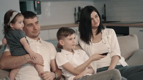 Family Relaxing on Couch Together at Home