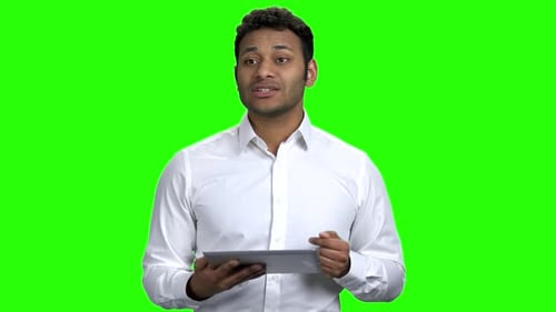 Young Adult Using Tablet on Green Screen