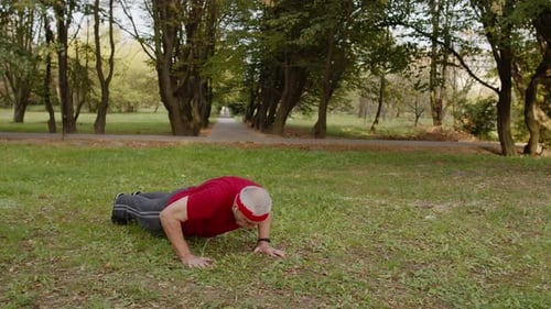 Active Senior Sportsman 80 Years Old Doing Push-ups Exercise. Workout Cardio in Park for Grandfather