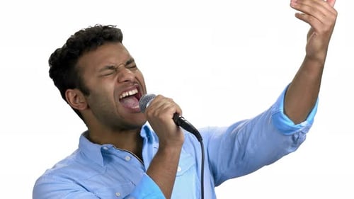 Young Adult Singing Passionately into a Microphone