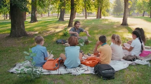 Outdoor Class with Children Learning in Park