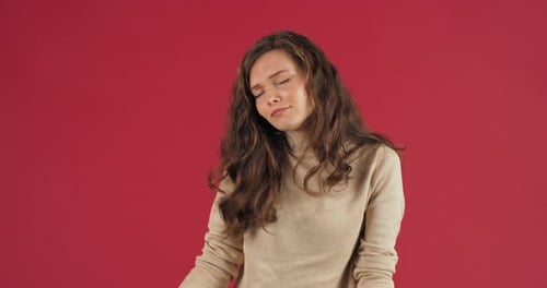 Crazy Cheerful Active Bright Winner Woman Teenager Girl with Long Hair Dancing in Studio on Red